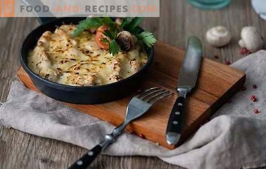 Julienne in a pan - a restaurant dish in the home kitchen. Homemade recipes Julienne with chicken and mushrooms in a pan