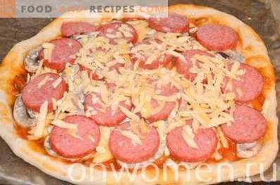 Pizza with sausage and mushrooms on yeast dough