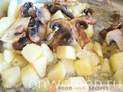 Potato fried with mushrooms in a pan