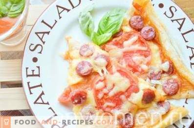 Pizza with hunting sausages and tomatoes