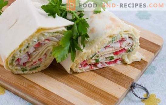 Lavash roll with melted cheese and crab sticks is an appetizer. Secrets of pita bread roll with cheese and crab sticks